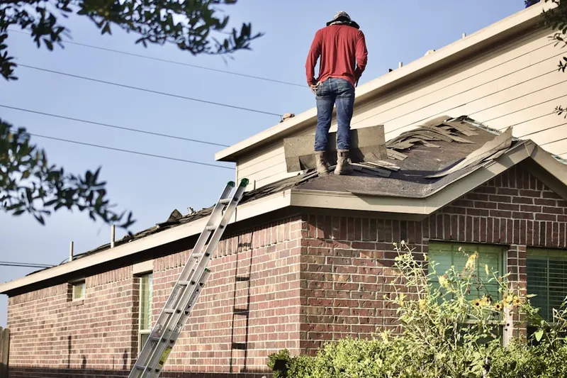 Professional roofer working on a residential roof in Pestletown